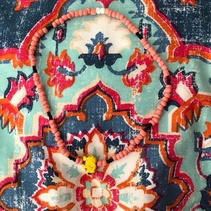 pink and black chocker with yellow elephant